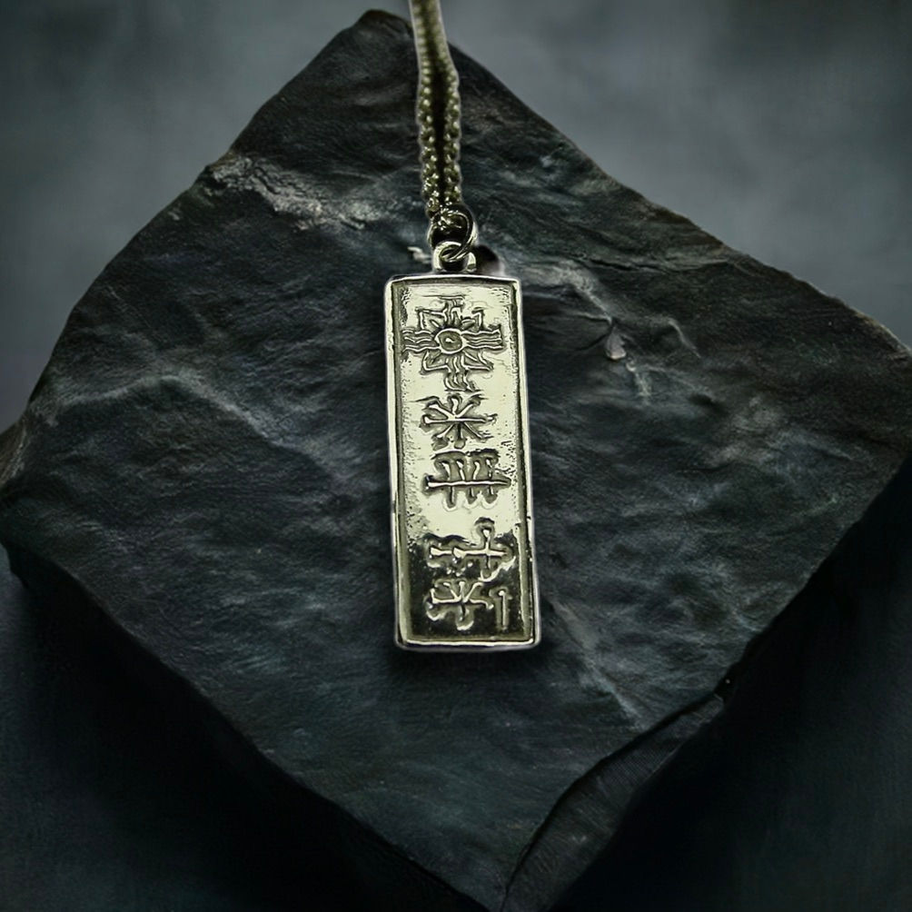 Silver Cuneiform Ishtar necklace on stone