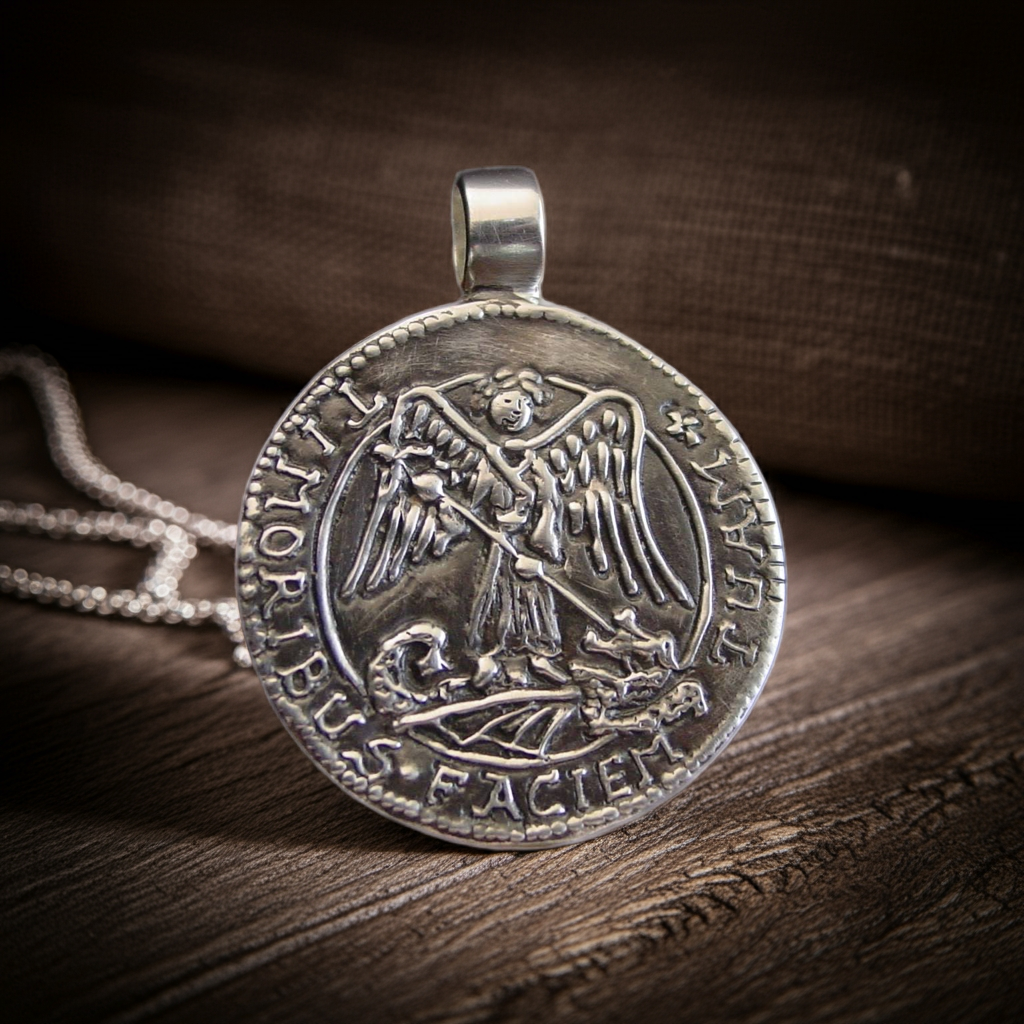 Archangel Michael silver pendant on table