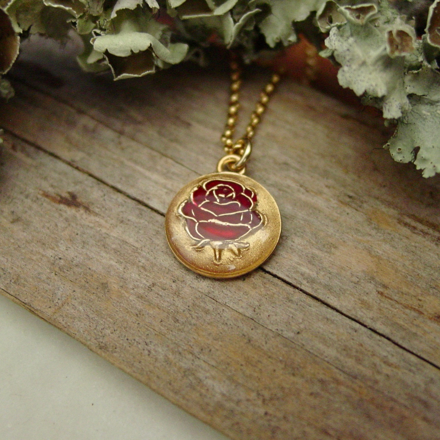 red rose necklace on wood