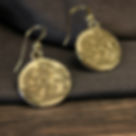 Epona coin earrings on  table