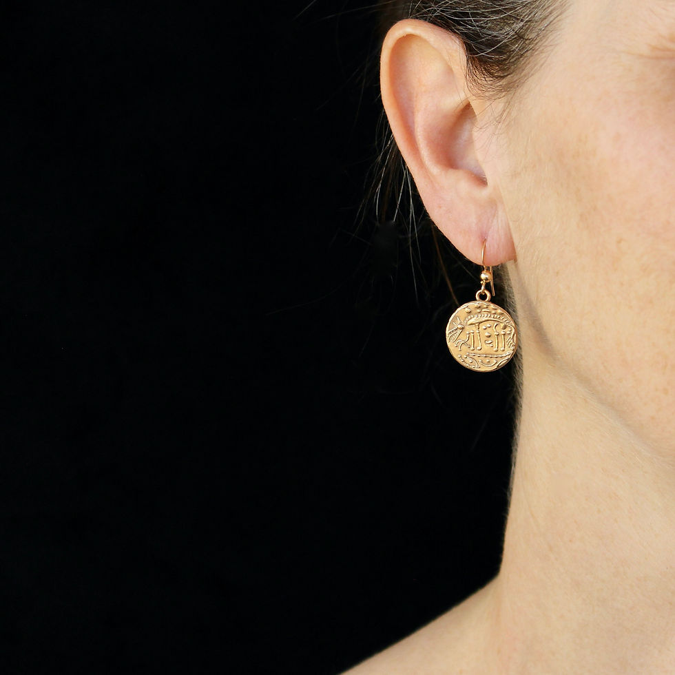 Celtic wolf coin earrings on woman