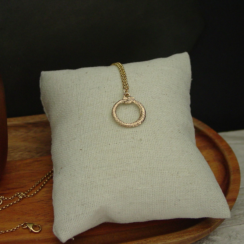 Thumbnail: Tiny Ouroboros necklace on linen