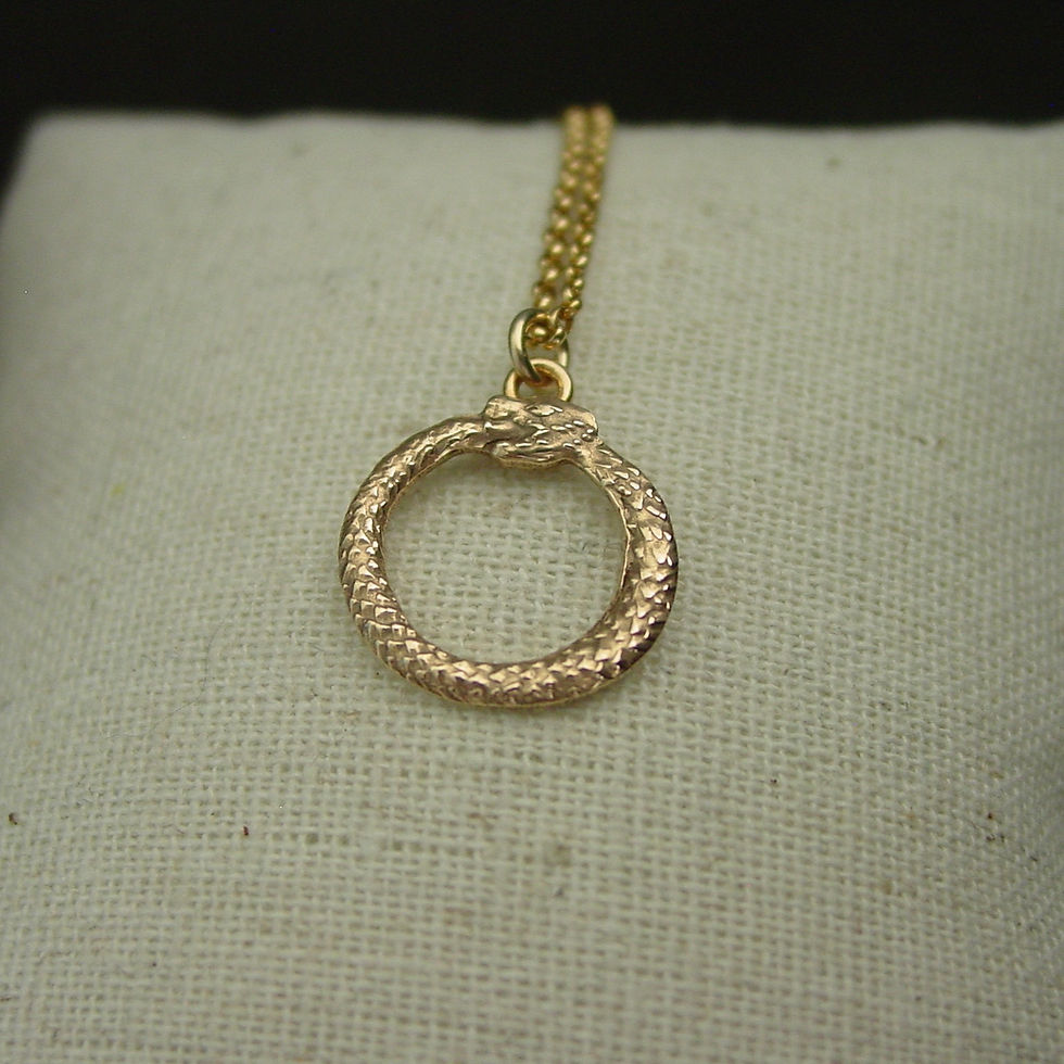 Thumbnail: Tiny Ouroboros necklace on pillow