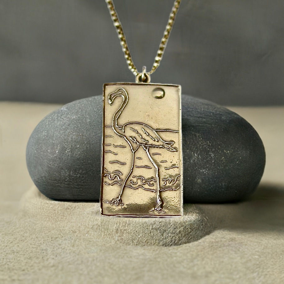Flamingo necklace on sand