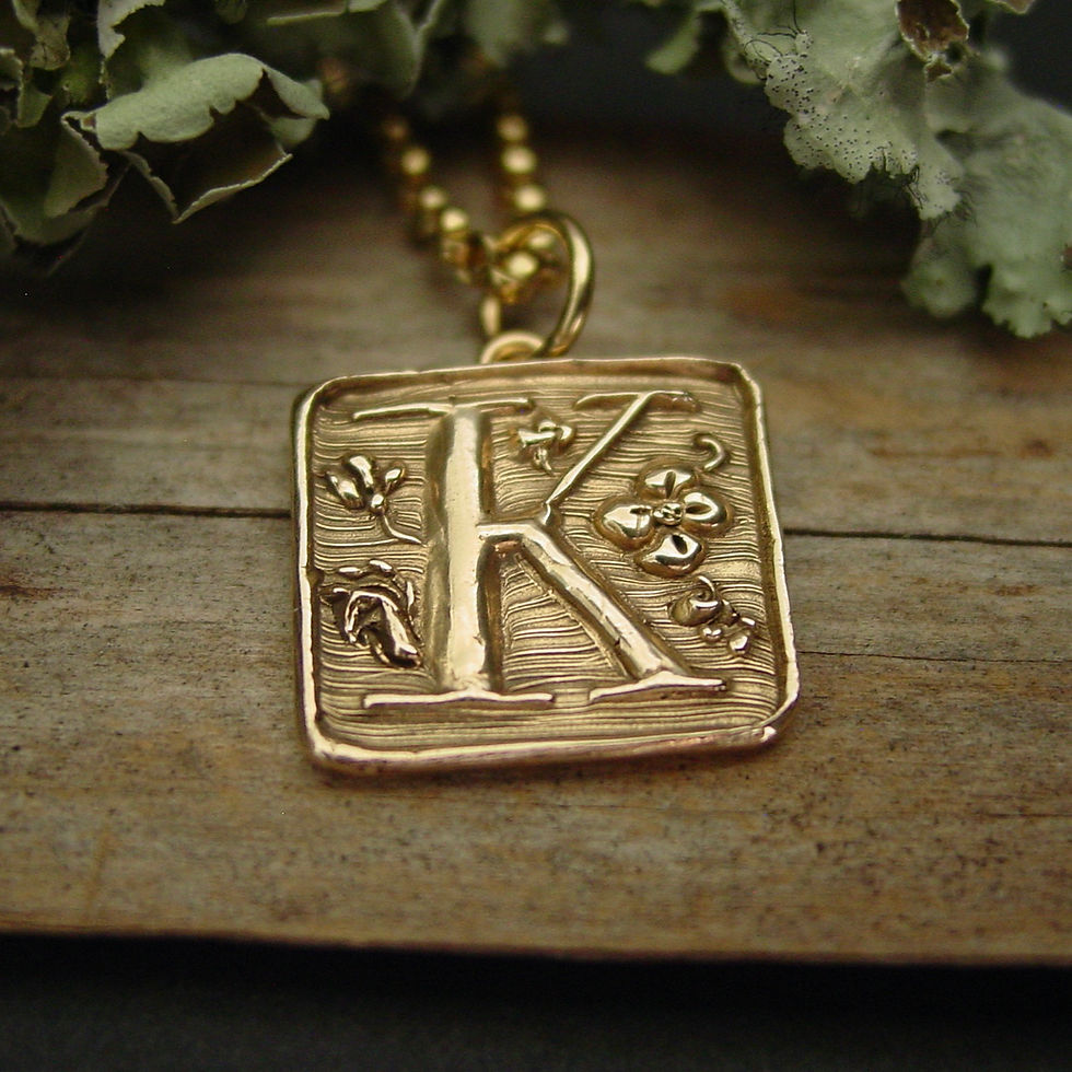 K initial necklace on moss