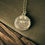 Thumbnail: Viking longship coin necklace on table