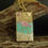 Thumbnail: Flamingo necklace on branch close up