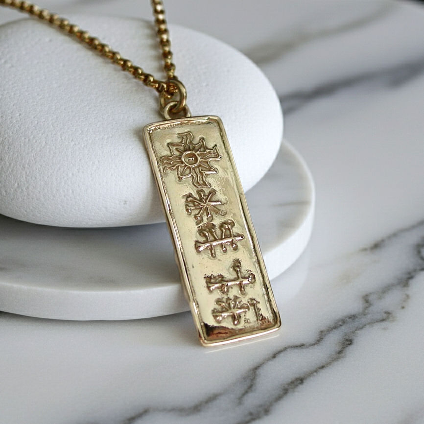14k gold cuneiform Ishtar necklace on marble