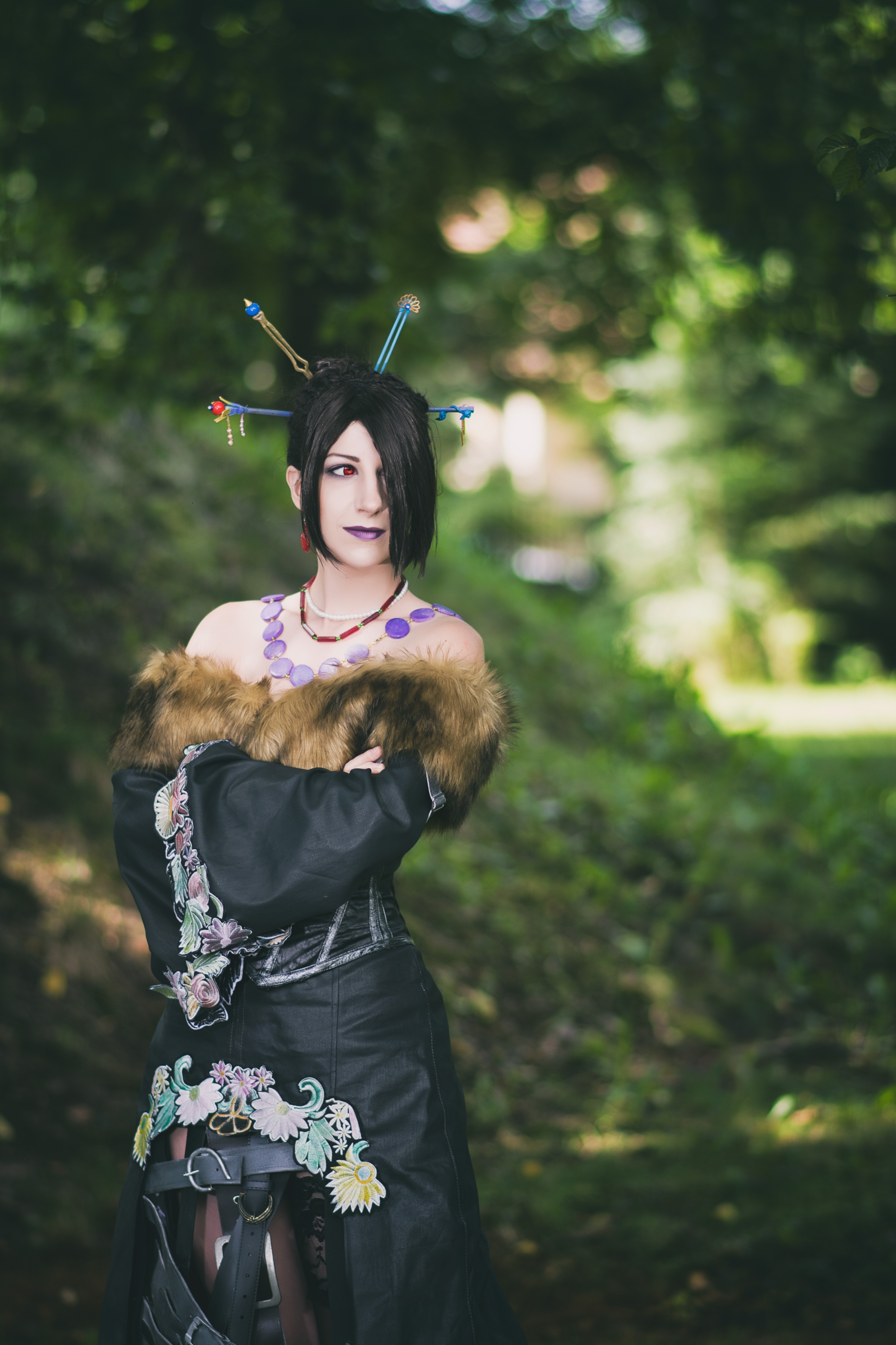 Lulu from Final Fantasy X standing in a garden.