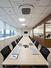 Modern Kohinoor conference room with long wooden table.