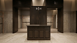 S&N branded luxury store interior with dark wood desk