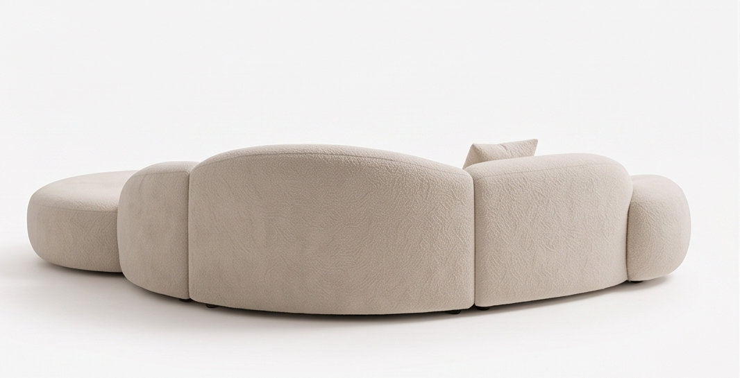Rear view of a curved Lusso Imperiale cream sofa section.