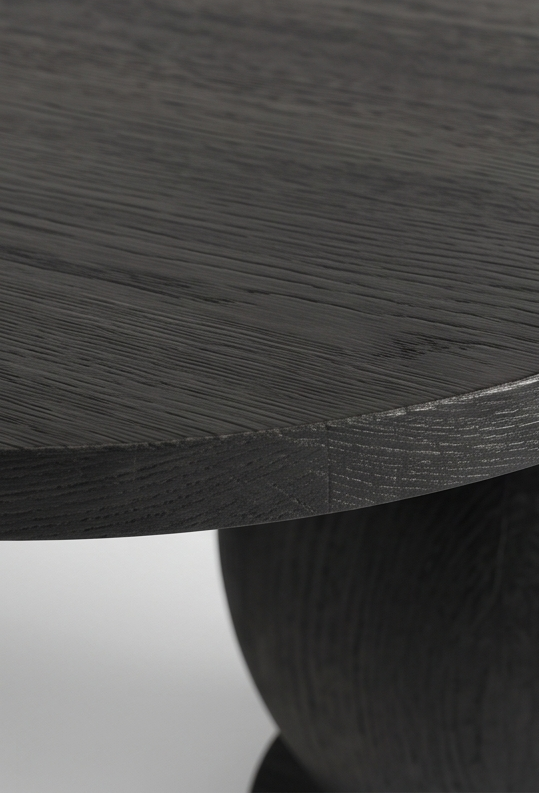 Close-up of AMALFI dark wood table surface and base.