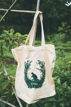 Illustrated tote bag in a natural setting for the young people's charity Grow. The tote bag is illustrated with an image of a person gardening, surrounded by plants