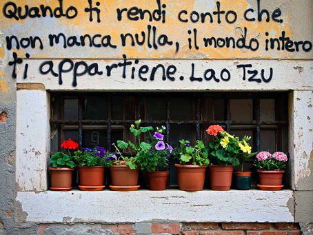 "Quando ti rendi conto che non manca nulla, il mondo intero ti appartiene" di Lao Tzu - Frasi sui muri