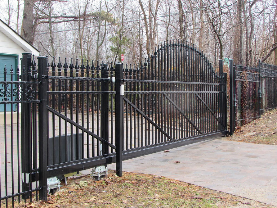 A house with a black colour wrought iron fence and a gate