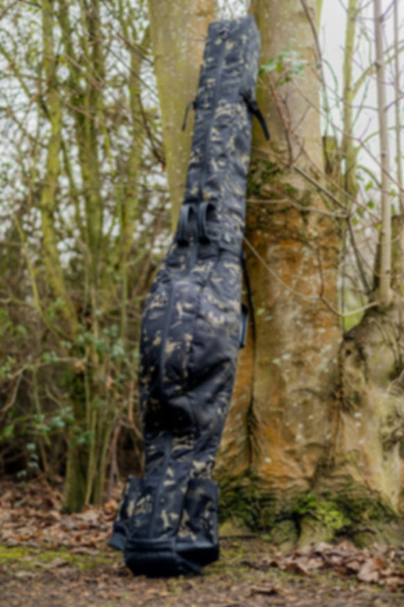 CarpLife 12ft carp rod holdall in Eclipse Camo leaning against tree on bankside
