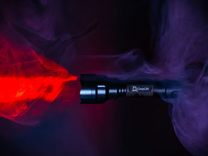 CarpLife bird scaring torch on a dark background glowing with a red beam in some fog