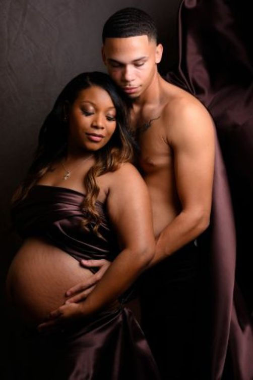 Studio maternity photographer in Killeen TX capturing intimate couple’s portrait with baby bump.