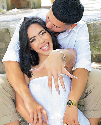 A newly engaged couple shares a joyful moment, her laughter lighting up the frame as she shows off her sparkling engagement ring. His embrace is tender and protective, perfectly balancing her excitement and affection. This portrait captures love in its purest form — fun, authentic, and bursting with energy. A Texas photographer like Michael Anthony knows exactly how to blend natural light and genuine emotion to create images that feel real. The soft background and warm tones add a timeless quality that enhances their chemistry. It’s a visual love letter that reminds couples of the joy and magic in every beginning.
