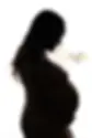 Silhouette of an expectant mother in a lace gown, cradling her belly, encapsulating the grace of pregnancy, with the My Canvas Portraits logo above.