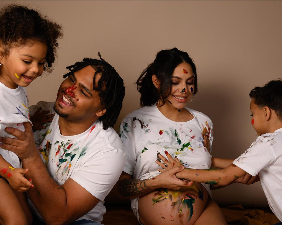 Parents and two children playing with paint during a family portrait session