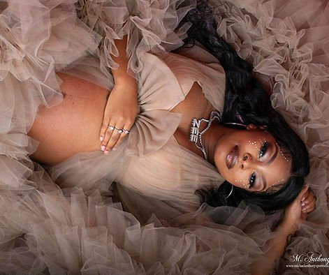 A radiant mother-to-be reclines gracefully in a soft cloud of beige tulle, her hand resting gently on her belly as her expression glows with anticipation. The layers of fabric create a dreamy, ethereal texture, enveloping her in warmth and serenity. Her delicate jewelry and natural beauty emphasize the sacredness of maternity. Captured by a Texas photographer who specializes in emotional storytelling, this portrait honors both motherhood and femininity. It’s not just about capturing pregnancy — it’s about documenting strength, peace, and the quiet miracle of new life. My Canvas Portraits turns these fleeting moments into timeless art that mothers will cherish for generations.