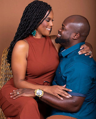 Engaged couple sitting close and smiling during a studio engagement photo session in Austin, Texas.