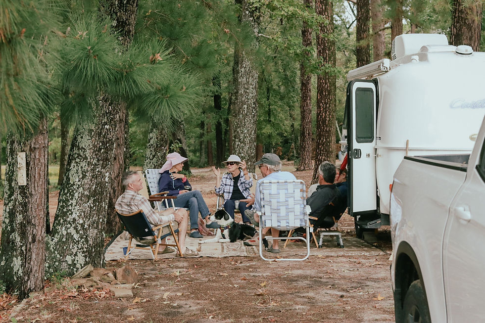 Campers sitting outside their campsite next to a casita rv at Salmon Lake Park.