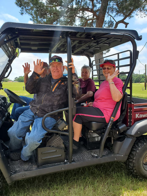 four people sitting in an atv