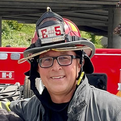 Photo of Brent Weir of Project 22:3 in a fireman hat.