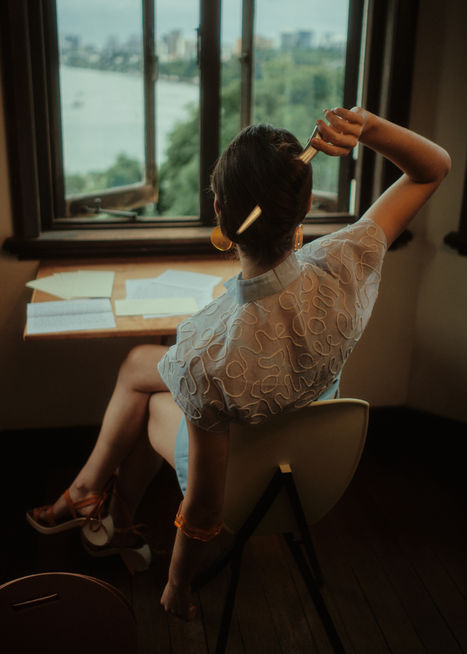 Cotton Organdy hand-embroidered button-down blouse in sky blue, with Wool-Cashmere hand-dyed bralette and shorts. Complete with lasercut timber, cotton, and leather handbag, timber and leather Apostrophe sandals, and  cast chrome letter opener.