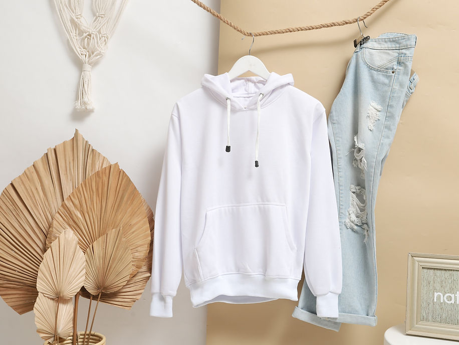 Plain white hoodie hanging on a studio background with jeans_edited.jpg
