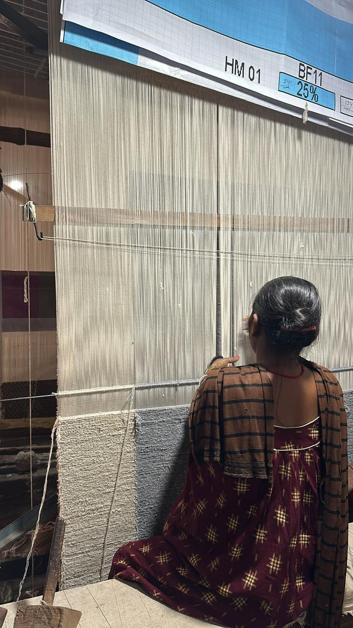 Close-up view of artisan weaving a colorful wool rug