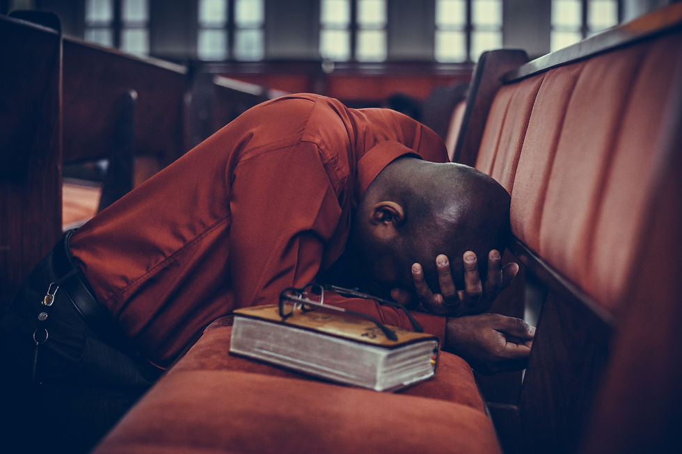 man praying in a church