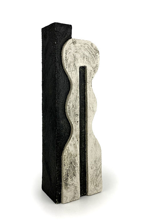 A black and white abstract sculpture with wavy and straight lines, resembling a modern art piece.