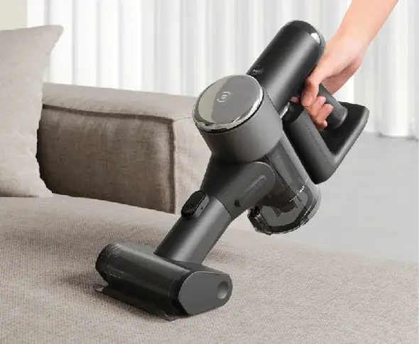 Miniatura: Handheld vacuum cleaner cleaning a carpet with a modern gray design. RAR