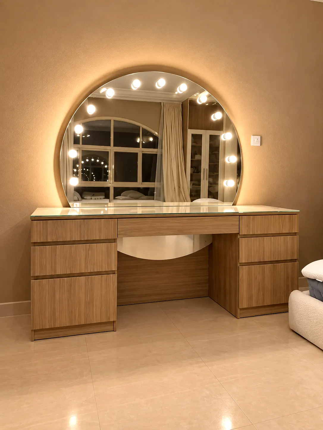 Timber vanity table with drawers and a round Hollywood-style bulb-lit mirror.