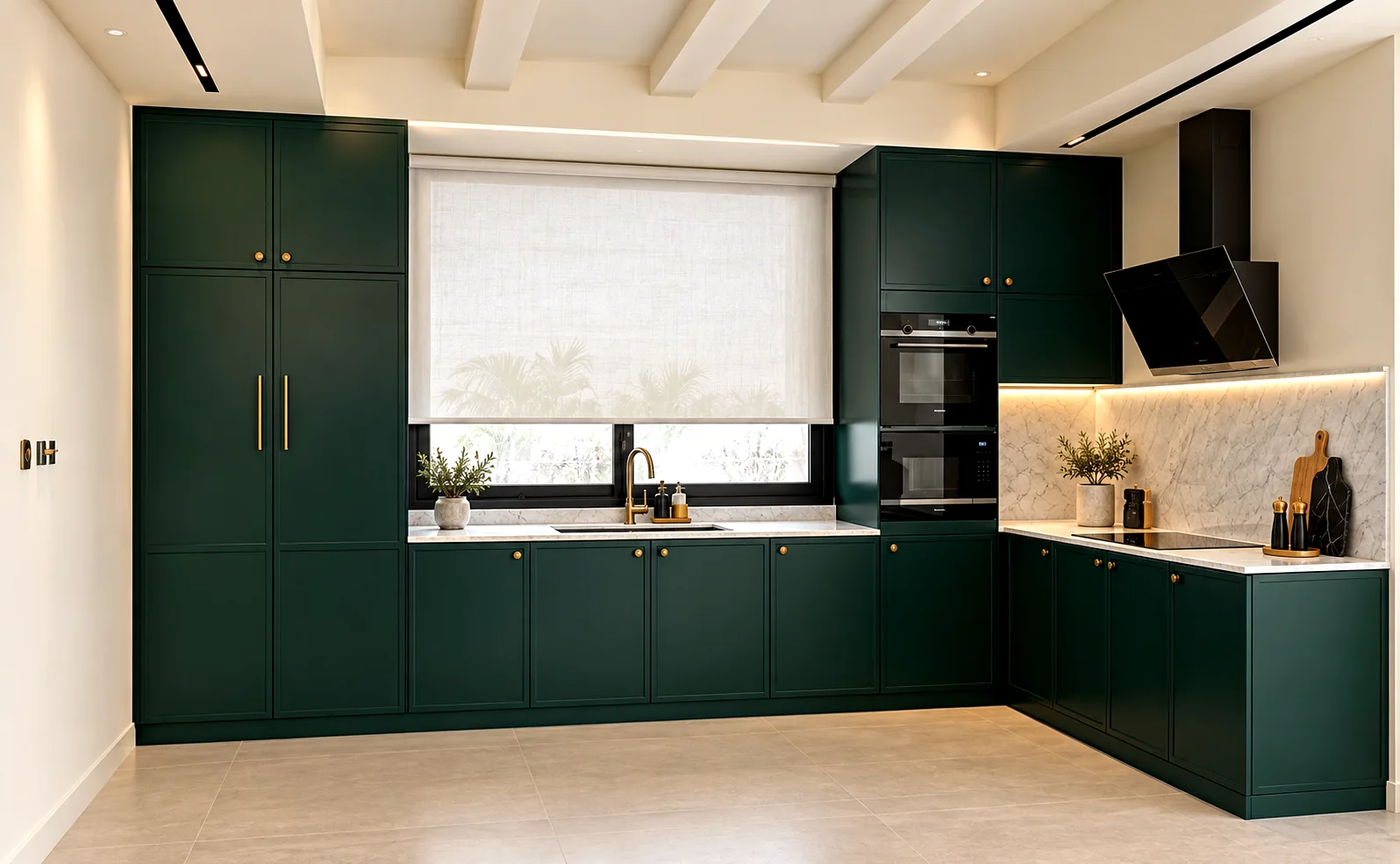 Forest-green L-shaped kitchen cabinets with brass handles, integrated appliances and a pale stone backsplash.