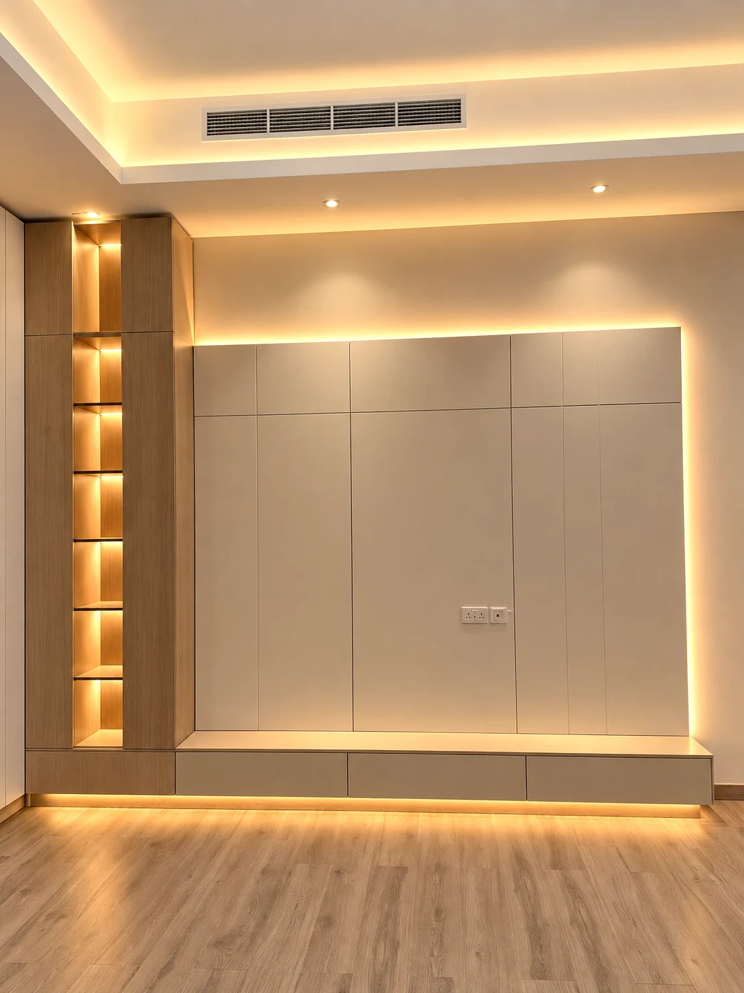 Pale TV backdrop outlined by warm lighting with timber display shelving and a floating cabinet.