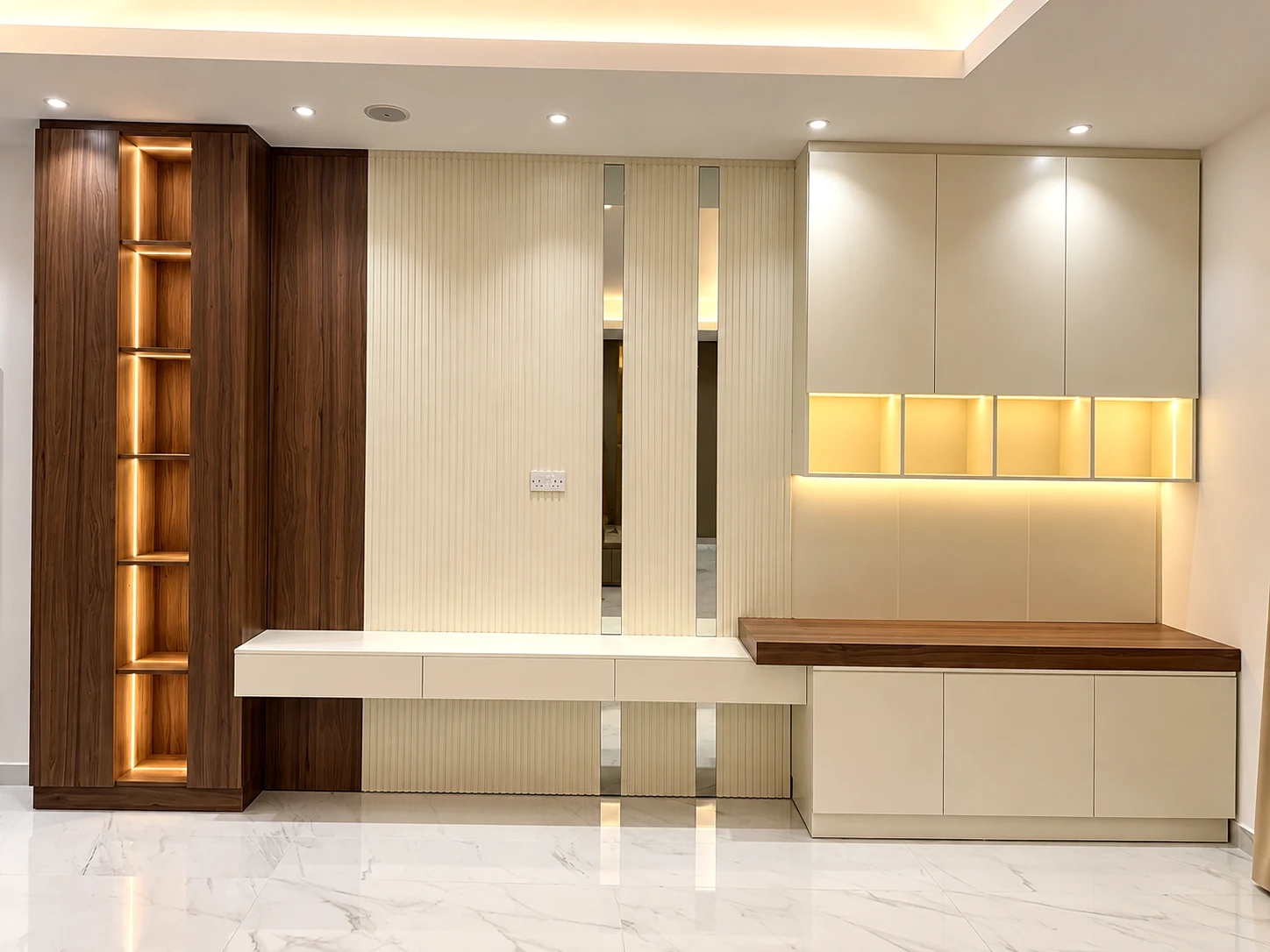 Fitted TV wall cabinetry with storage drawers, illuminated shelves and an integrated study desk.
