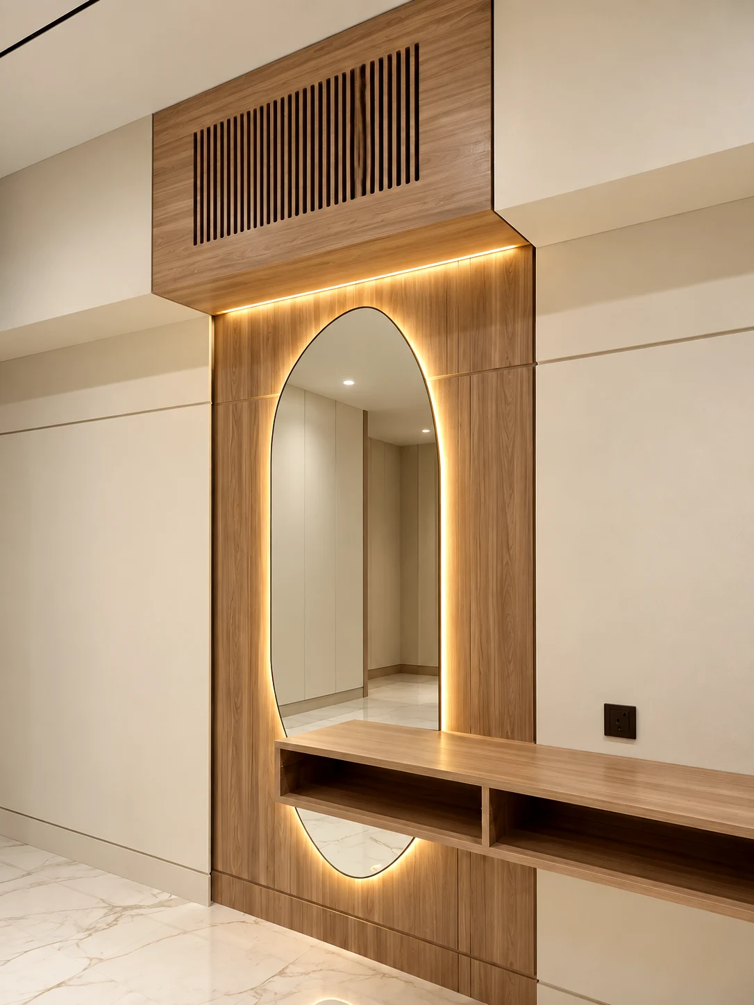 Floating timber vanity shelf with an oval mirror and warm perimeter lighting.