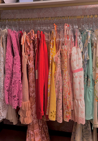 colorful clothing rack that you can find in our storefront. Dresses in rainbow order