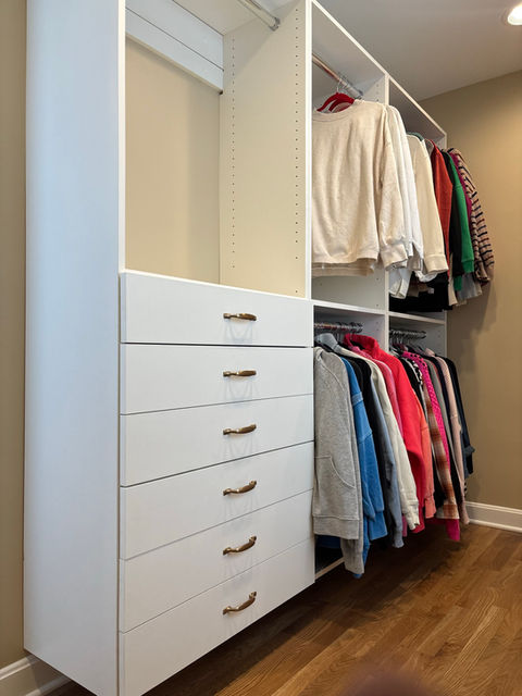 White custom closet system with drawers and hanging rods