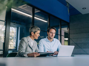 Accountant and property investor reviewing financial advice on a laptop.