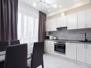 Modern New Zealand kitchen showing common chattels like oven, microwave, and dining set