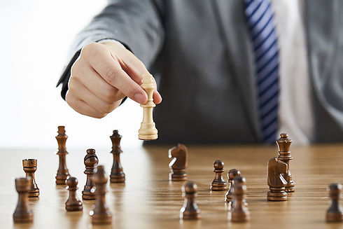 businessman in suit playing chess