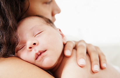 a woman holding a baby