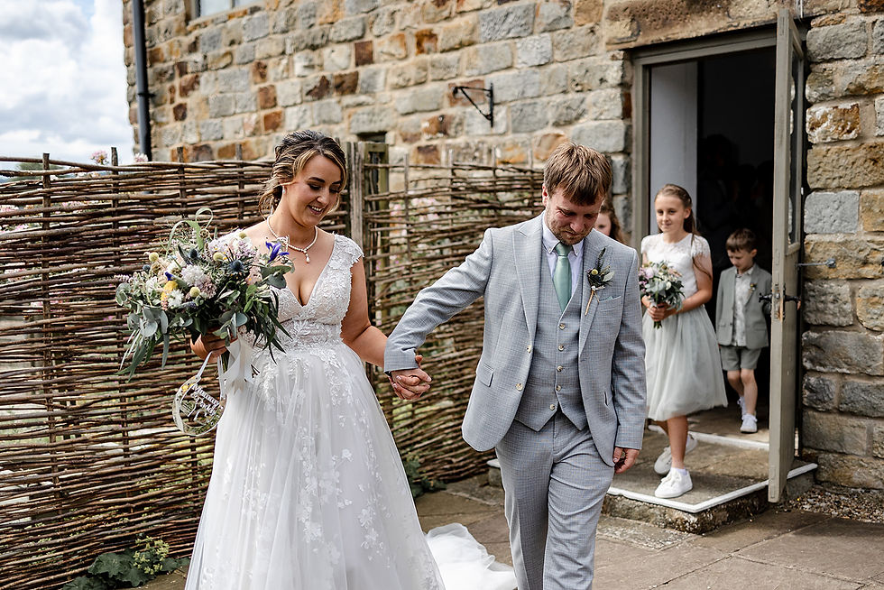 Couple in the moment leaving their wedding ceremony