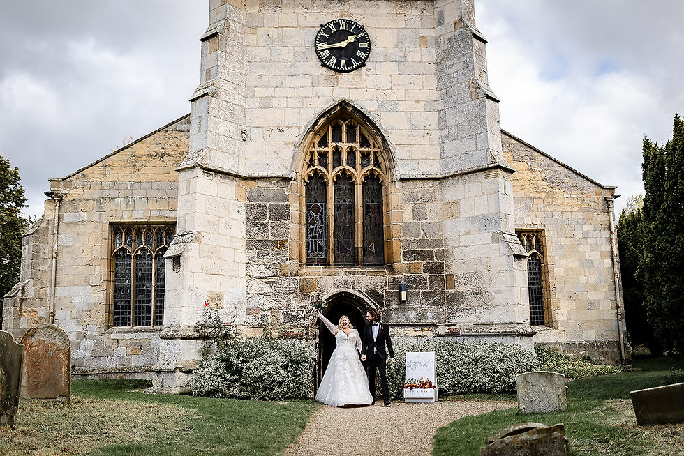 Bride and groom walking out of Setterington Church after winter wedding ceremony in North Yorkshire